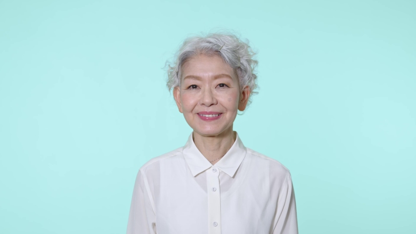 Asian senior woman wearing glasses. | Shutterstock HD Video #1090438811