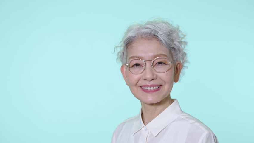 Asian senior woman wearing glasses. | Shutterstock HD Video #1090438827