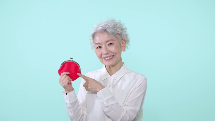 Asian senior woman laughing with her wallet. | Shutterstock HD Video #1090438843