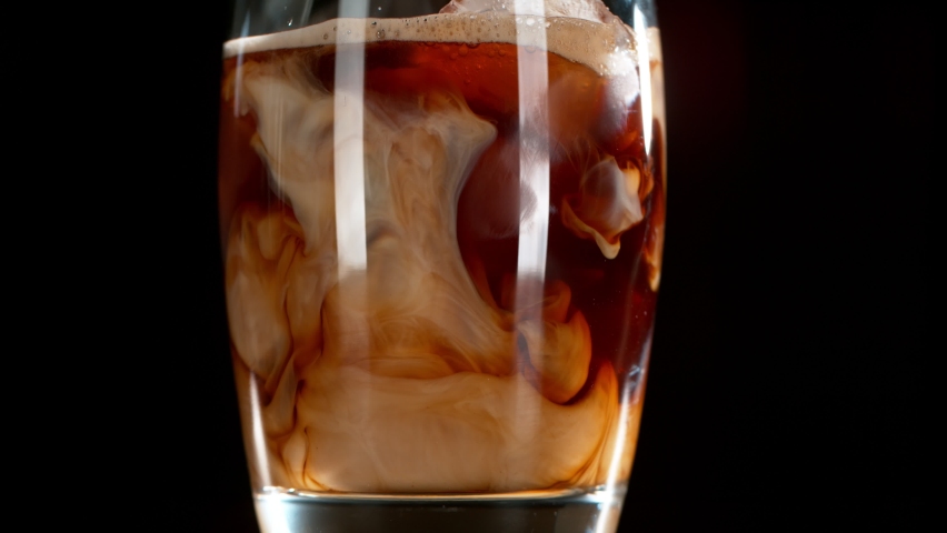 Super Slow Motion Shot of Pouring Cream into Ice Coffee at 1000 fps. | Shutterstock HD Video #1090440929