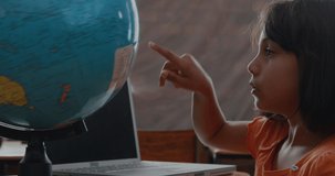 Animation of mathematical equations over caucasian schoolgirl with globe. global education and school concept digitally generated video.