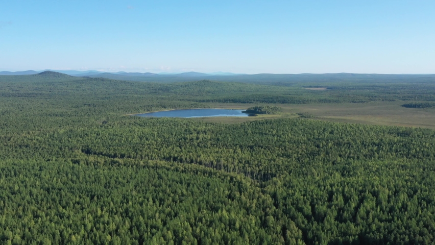 Top view of blue winding lake in the forest