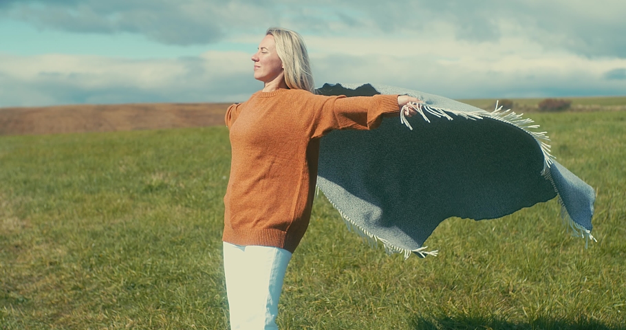 Happy woman enjoying, around nature, Woman in wool sweater and plaid at walk fresh air. Health care, authenticity, sense of balance and calmness. Joyful Moments. 4K video | Shutterstock HD Video #1090443409