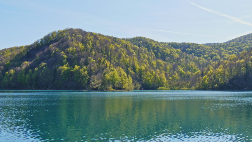 Peaceful lake with turquoise water in Plitvice Lakes National Park Croatia. Inscribed on the UNESCO World Heritage list due to its picturesque series of tufa lakes and caves connected by waterfalls 4K