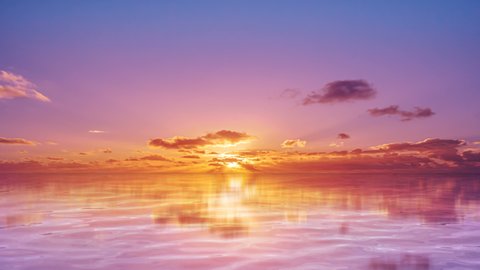 Amazing Colorful ocean sunset with Pink clouds, Majestic sunset over ocean and the sky is reflected in the sea idyllic tranquil seascape, Meditation ocean and sky background.
