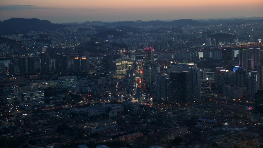 Illuminated Seoul at sunset. Night aerial panorama of Seoul in South Korea. Seoul city skyline. High quality 4k footage