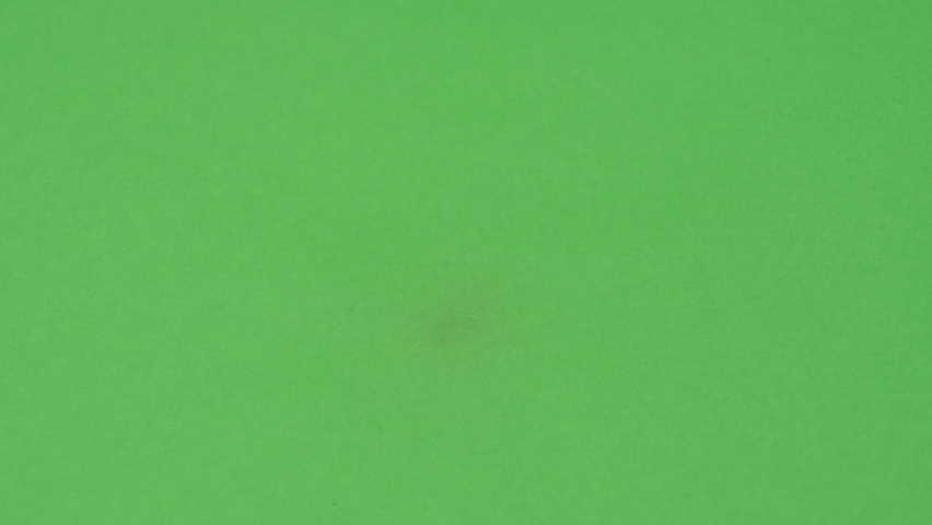 Green screen burning from center hole fire. Black behind, background. 
Perfect for a nice organic transition. In camera, recorded footage, no effects. Easy to map and apply matte to your transition. | Shutterstock HD Video #1090446247