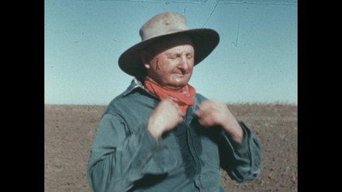 1880s: farmer wipes sweat from brow with neckerchief. Man unwraps oat cake in field.