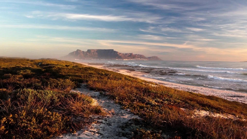 scenic view of table mountain landmark from blouberg in cape town south africa with empty beach
