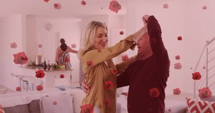 Animation of rose icons over diverse group of seniors dancing and cooking. senior home hangout and digital interface concept digitally generated video.