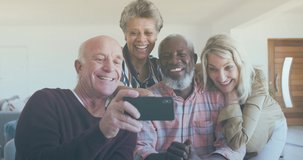 Animation of media icons over diverse group of seniors taking selfie. senior home hangout and digital interface concept digitally generated video.