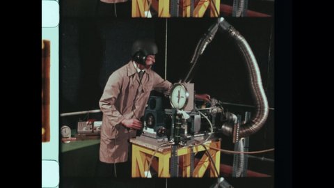 1984 Mojave, CA. Weird Science. Man in Helmet test RPM Gauge on strange industrial machine. Close Up of Scale, RPM Gauge. Close Up of Hand adjusting piston engine. 4K Overscan of Archival Science Film