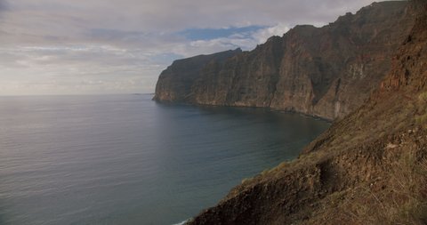 Los Gigantes steep huge cliffs rock wall bordering the blue atlantic ocean seascape. Tenerife, Spain, Canary islands, europe.