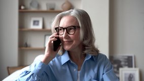 Happy middle aged senior caucasian woman grandma relaxing on cozy sofa talking on smartphone. Close-up female face elderly lady sharing news on mobile phone - Powered by Shutterstock - Get 15% off with code: PIKWIZARD15