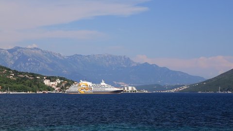 Seascape, a large white cruise liner stands in Bay of Kotor, near high mountains, Montenegro. Tourism, travel, recreation. Liner on ocean, summer vacation. Herceg Novi, Montenegro, 2021-06-17
