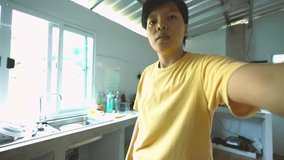 happy Asian short hair woman is video calling to her friends at home to show off the kitchen, interior designed and decorated by himself. Technology concepts and interior decoration. 4K video