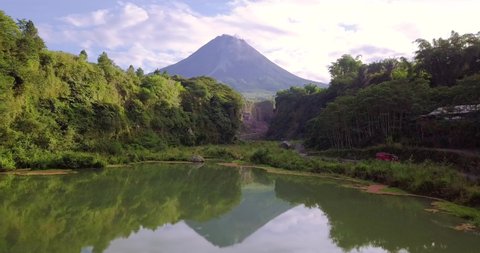 View of Merapi volcano from a lake in Bego Pendem. Indonesia. cinematic shot