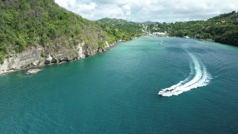 Speedboat coming out of Marigot Bay, captured by drone. A beautiful hidden gem along St.Lucia's coastline.