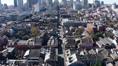 Aerial descending and tilting up shot of Bourbon Street in the French Quarter of New Orleans during the day. 4K