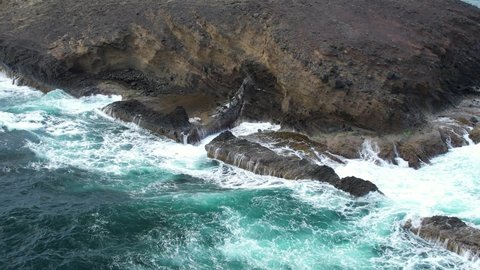 Spray from blowhole with waves crashing around. Close up aerial shot of St.Lucia's East coast.