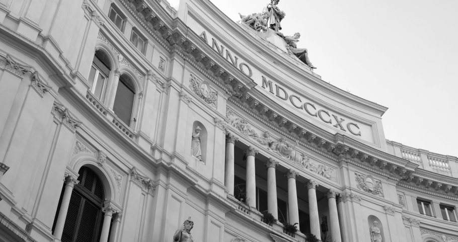 Panning across European style architecture of Galleria Umberto I with beautiful pillars, balconies and roman letters in black and white in Naples, Italy.