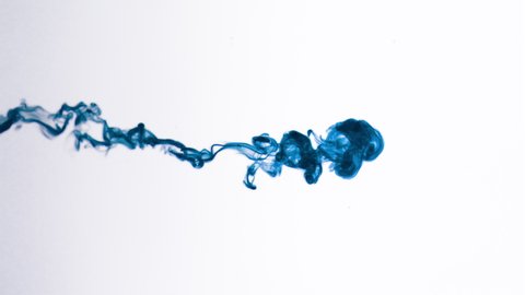 Super slow motion isolated Blue Ink Cloud floating in clear water. Macro Slow Motion Shot on White Background with selective focus framed for vertical, horizontal video and compositing plate.