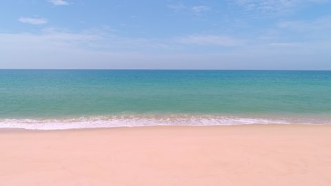 Amazing sea ocean with waves break on pink sand beach waves crashing against an empty beach.Sea waves and beautiful pastel color romantic sand beach High quality video Bird's eye view
