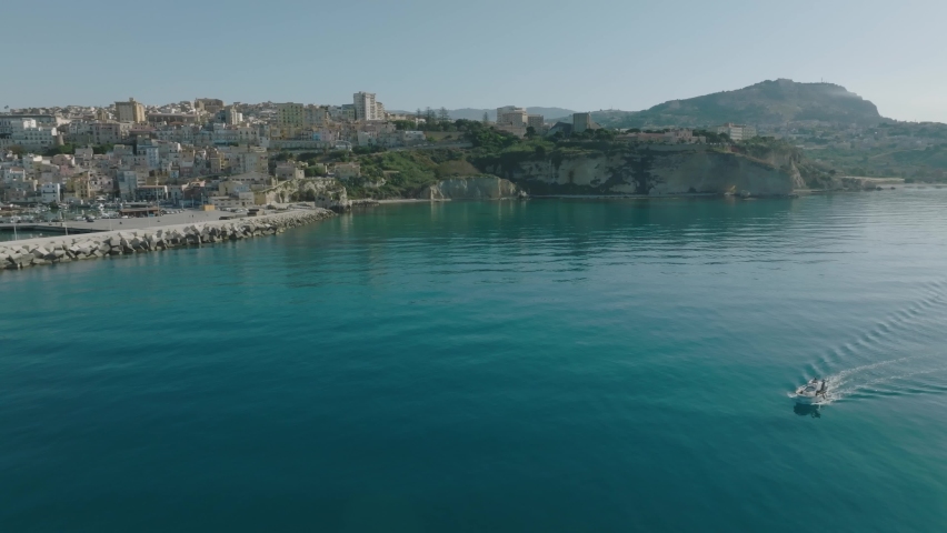 Drone shooting of the coast of Sciacca in Sicily. Harbor with fisherman, costa della volpe, castle and panoramic view of the city of Sciacca. Dixmunde sea war memorial and thermal baths.