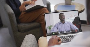 African american businessman using laptop for video call with african american business colleague. business communication technology and digital composite video.