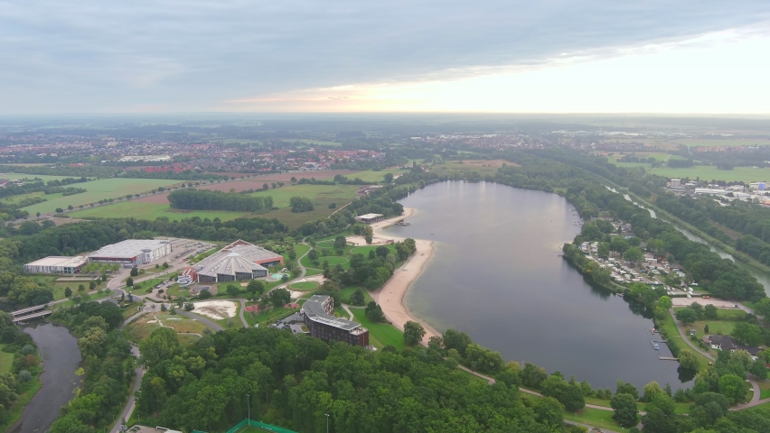 Wolfsburg, Germany: Aerial view of city in Lower Saxony, lake Allersee in morning - landscape panorama of Europe from above | Shutterstock HD Video #1090469209