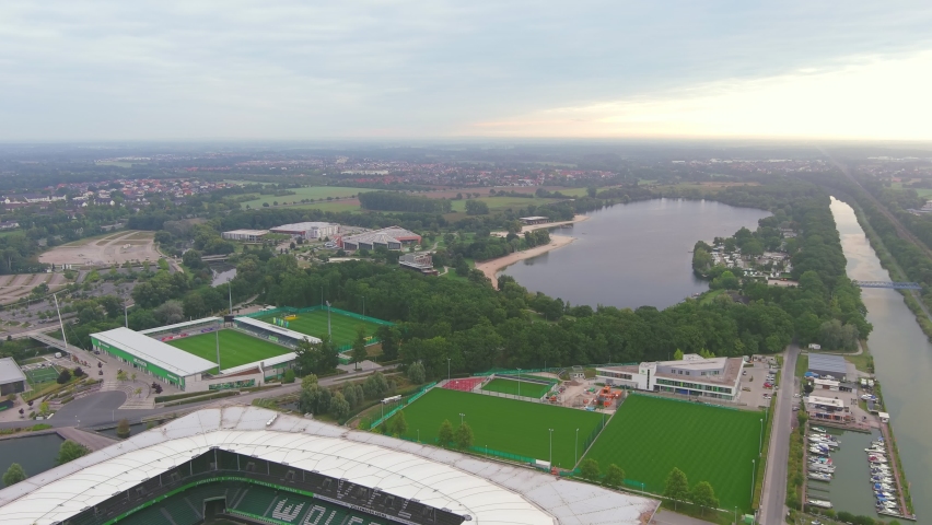 Wolfsburg, Germany: Aerial view of city in Lower Saxony, lake Allersee in morning - landscape panorama of Europe from above | Shutterstock HD Video #1090469211