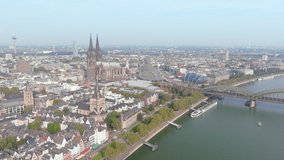 Cologne, Germany: Aerial view of city Cologne (Köln) on river Rhine, skyline with Cologne Cathedral (Kölner Dom) in historic city center - landscape panorama of Europe from above