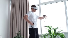 young man in sports clothing doing squat while wearing virtual reality glasses. Training Via Augmented Reality Application, Futuristic Fitness, Smart Sport And Technology Concept