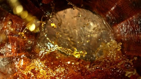 Super slow motion of pouring whiskey, rum or cognac inside the barrel. Filmed on high speed cinema camera, 1000fps. Ultimate composition view inside the wooden keg.