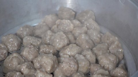 Meatballs being cooked by steaming