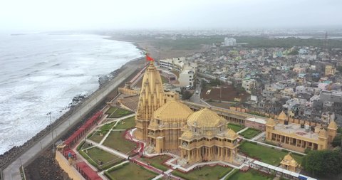 somnath , Gujarat , India - 05 18 2022: Beautiful aerial rotating shot over the Somnath Mahadev Temple, Gujarat, India. Somnath Mahadev Mandir is the oldest jyotirlinga of India with the view of Arabi