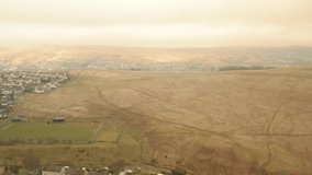Aerial view, rise up move. Drone shot of town in SouthWales Brecon Beacons mountains in Wales 