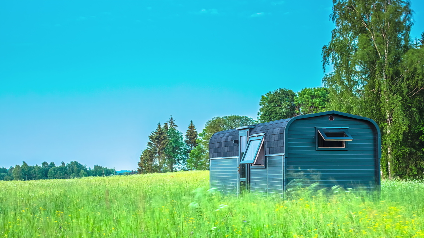 Brilliant Moon Rising In Blue Sky Over Green Fields With A Small Cabin In The Night. - Timelapse, Static
