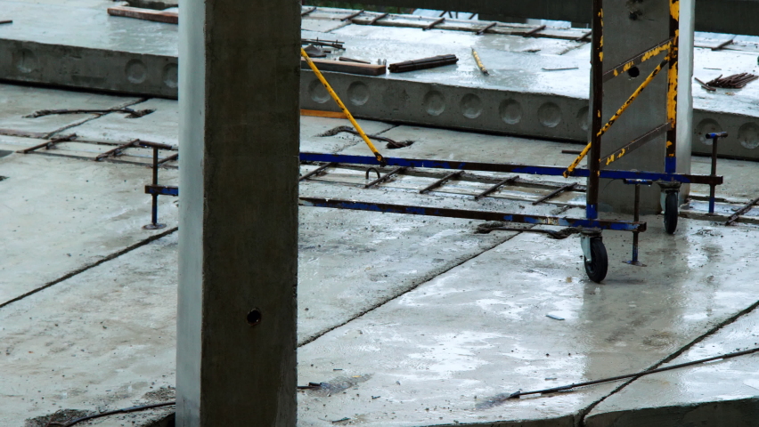 Construction site on the rain. Foundation, floors, concrete piers and piles of skyscraper. High rise building construction. Empty construction site of a large building under heavy rain. Bad weather Royalty-Free Stock Footage #1090481373