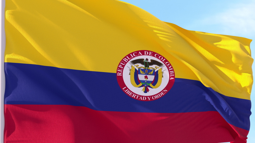 Colombia Flag Looping Background fluttering in the wind against a blue sky on a seamless loop.