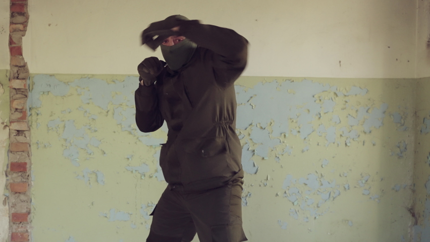 A soldier in a balaclava trains boxing skills. A fight with a shadow. | Shutterstock HD Video #1090483119