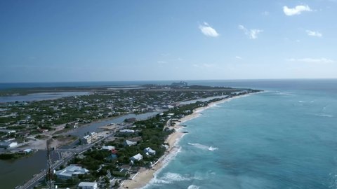 Drone camera flies toward coastal area of Cockburn Town, Grand Turk, Turks and Caicos, aerial footage from tropical island
