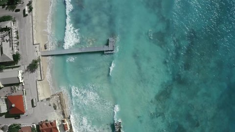 High angle overhead aerial footage of pier and seashore, drone view, Cockburn Town, Grand Turk, Turks and Caicos
