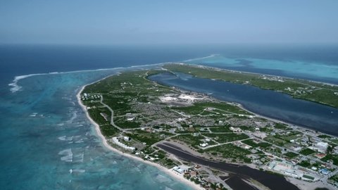 Drone camera flies over Cockburn Town, Grand Turk, Turks and Caicos, aerial panoramic video of Caribbean island coastline
