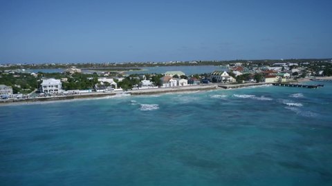 Aerial camera flies off coastal area of Cockburn Town, drone from above footage from Grand Turk, Turks and Caicos
