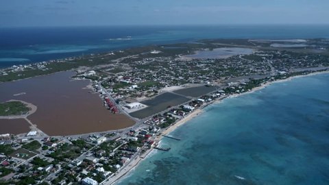 Aerial view of Cockburn Town with saline lake in the middle in the middle of the Grand Turk island, drone panoramic footage of Turks and Caicos
