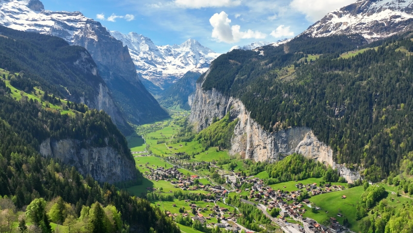 Picturesque Swiss valley of Lauterbrunnen on a sunny day, green alpine valley in Switzerland, famous tourist destination, the village of Lauterbrunnen Royalty-Free Stock Footage #1090484055