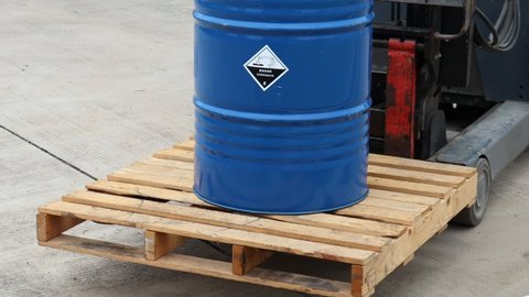 Corrosive chemical symbols on a blue chemical tank