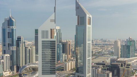The view on Emirates Towers and Sheikh Zayed road aerial timelapse. Skyscrapers of financial district on a background