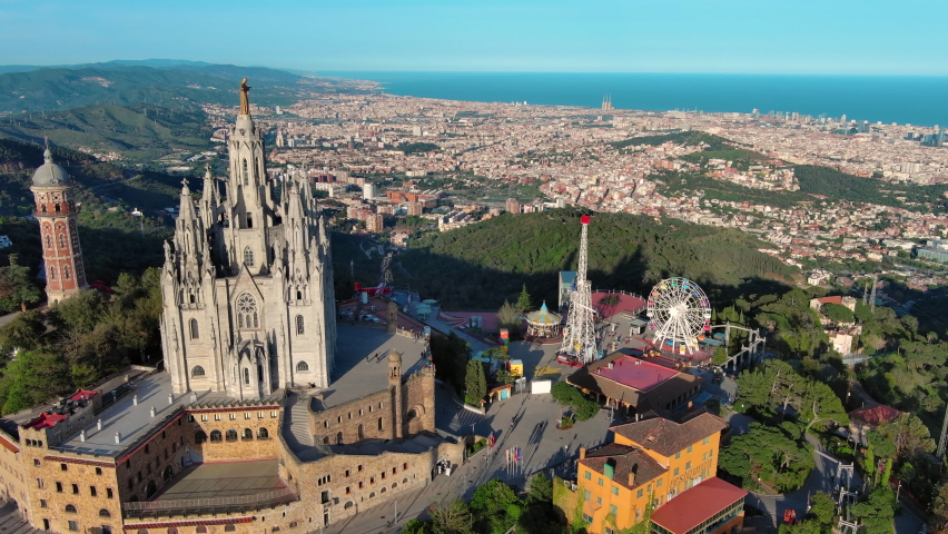 Aerial view of Barcelona skyline with Sagrat Cor temple at sunset, Catalonia, Spain | Shutterstock HD Video #1090487021